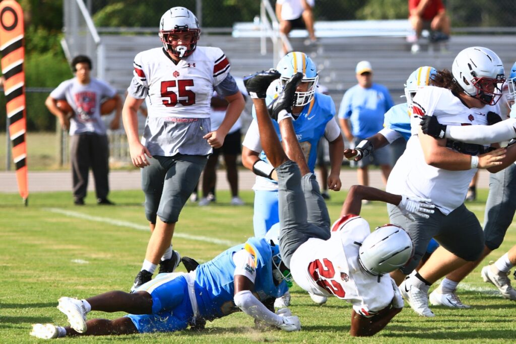 Chiefland's Brayden Hankins (3) upends a Santa Fe Catholic (Lakeland) running back in the backfield on Friday. Photo by C.J. Gish
