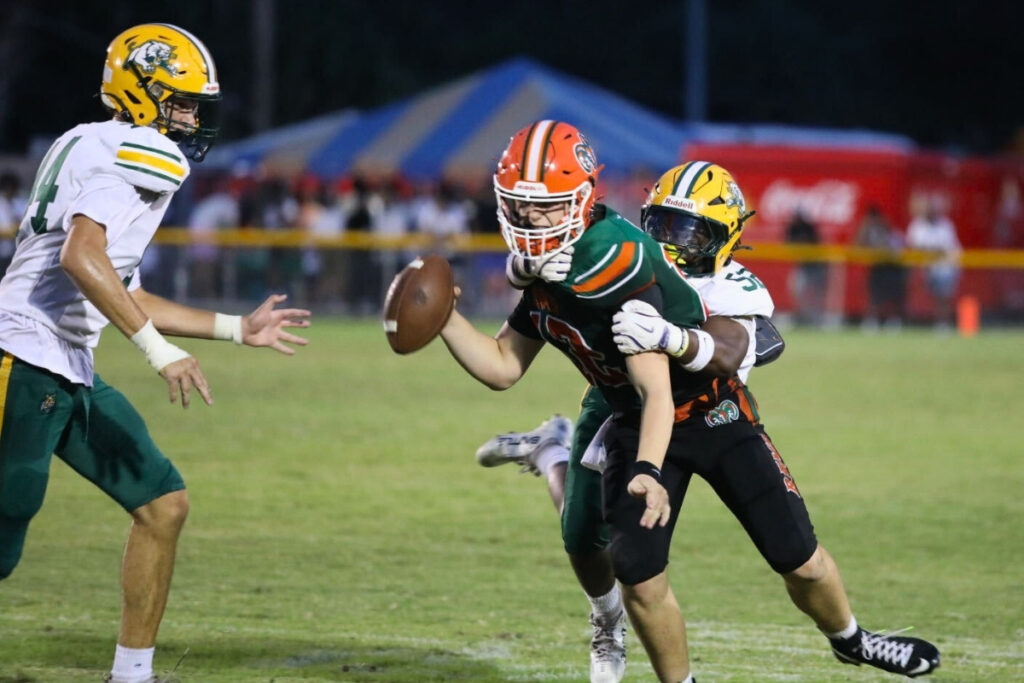 Eastside quarterback Cade Sutherland under pressure against Forest (Ocala) on Thursday. Photo by Walker Smith