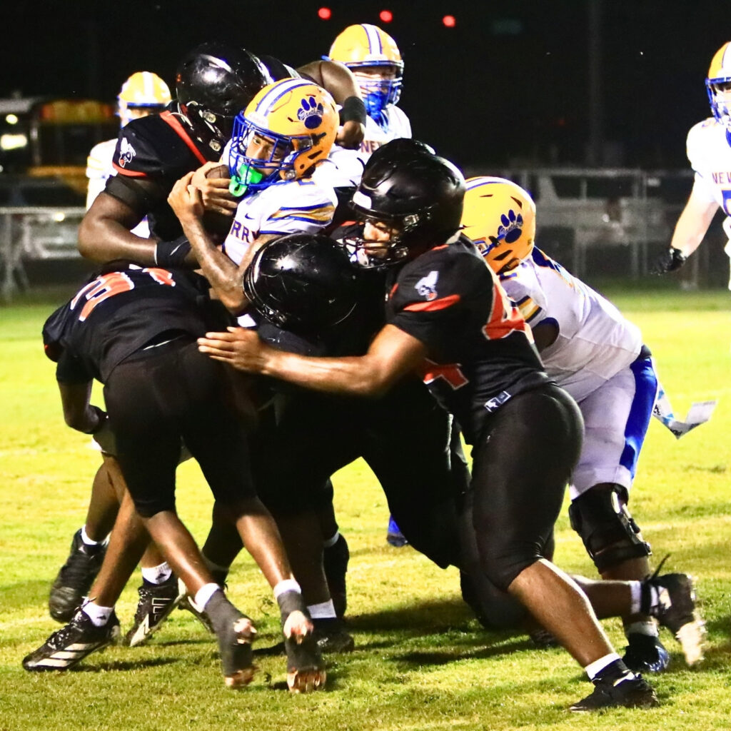 Hawthorne defenders bottle up Newberry's Derris Ford in the third quarter on Friday. Photo by C.J. Gish