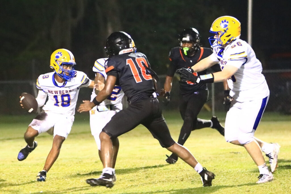 Hawthorne defenders close in on Newberry's Zach Chong-you (18) for a safety in the third quarter on Friday. Photo by C.J. Gish