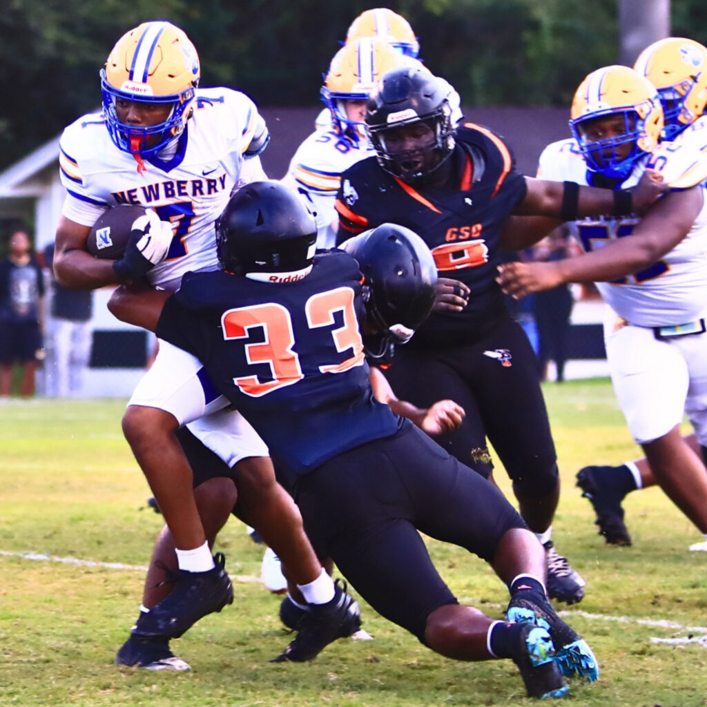 Hawthorne's Jelani Bently (33) brings down Newberry's Darius Debose (7) in the first quarter on Friday. Photo by C.J. Gish