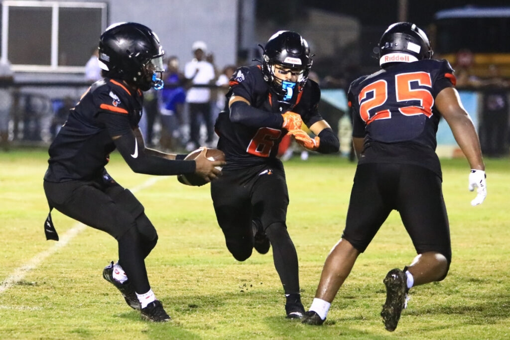 Hawthorne's Richard Roundtree Jr. (1) fakes a handoff to Raul Alvarez (6) against Newberry in the second quarter on Friday. Photo by C.J. Gish