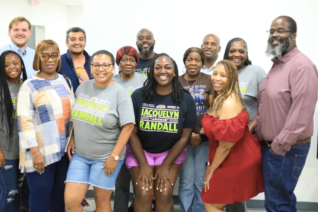 Jacquelyn Randall, in the center with a black shirt, and supporters gathered in Gainesville for an election watch party. Photo by Seth Johnson