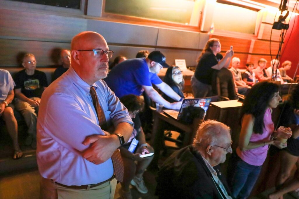 Mayor Harvey Ward watches election results with a packed room at Heartwood Soundstage on Tuesday. Photo by Walker Smith
