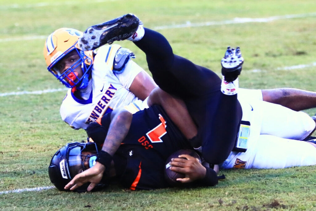 Newberry defenders bring down Hawthorne's Richard Roundtree Jr. (1) on Friday. Photo by C.J. Gish