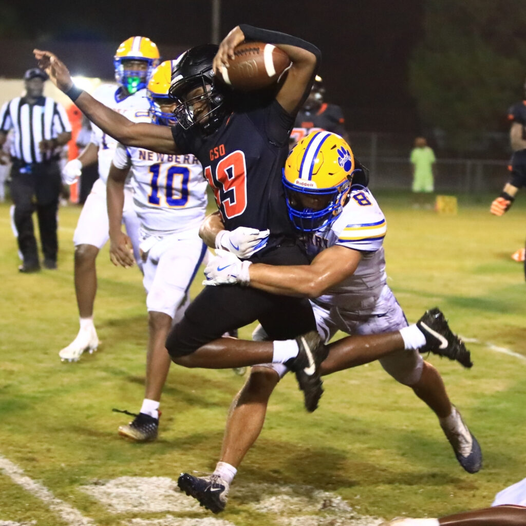 Newberry's Isaiah Johnson (8) tackles Hawthorne's Leveon Harris (19) in the third quarter on Friday. Photo by C.J. Gish