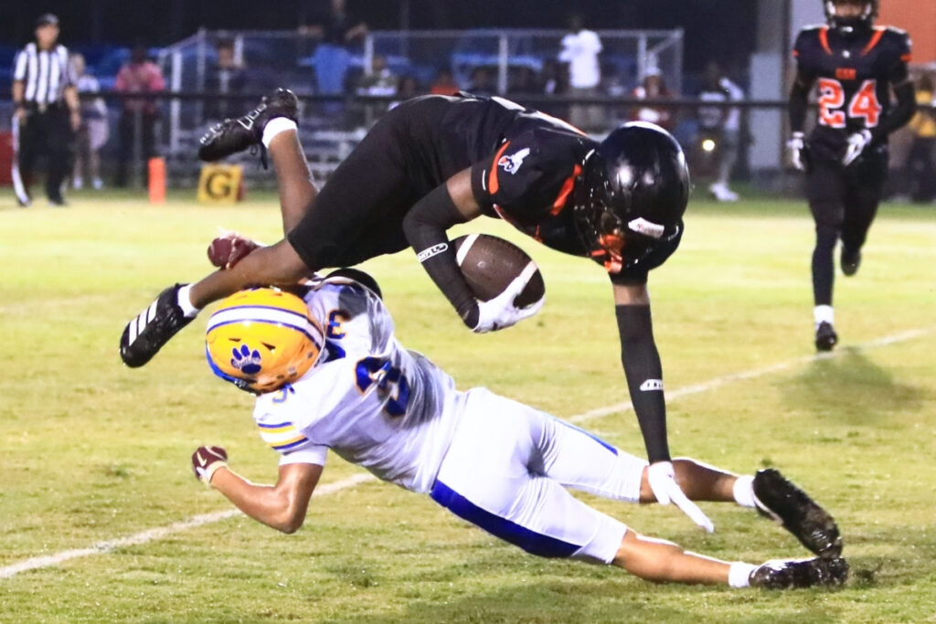 Newberry's Keyondre Williams (3) upends Hawthorne's Maverick Jones on a second-quarter punt return on Friday. Photo by C.J. Gish