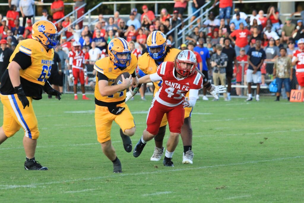 Newberry's Kieran Whitesides scrambles for yardage. Photo by Seth Johnson