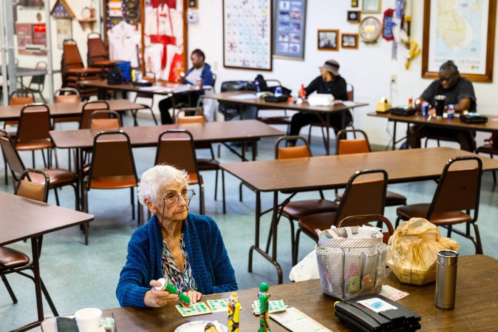 Participants compete during a Sunday afternoon bingo game at VFW Post 2811 in Gainesville, Florida. Players raise their hands once they've completed a winning pattern on their cards.