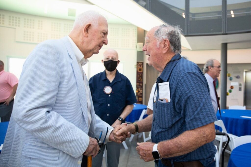 Roy Hunt (left) chats with Dr. Mark Barrow, founder of the Matheson History Museum. Robert Mounts, a past president of the Matheson, is in the background.