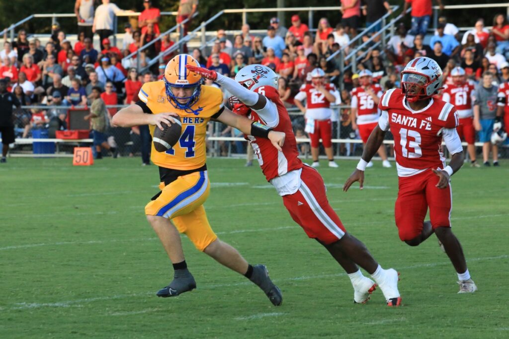 Santa Fe pressure results in a sack against Newberry's Kieran Whitesides. Photo by Seth Johnson