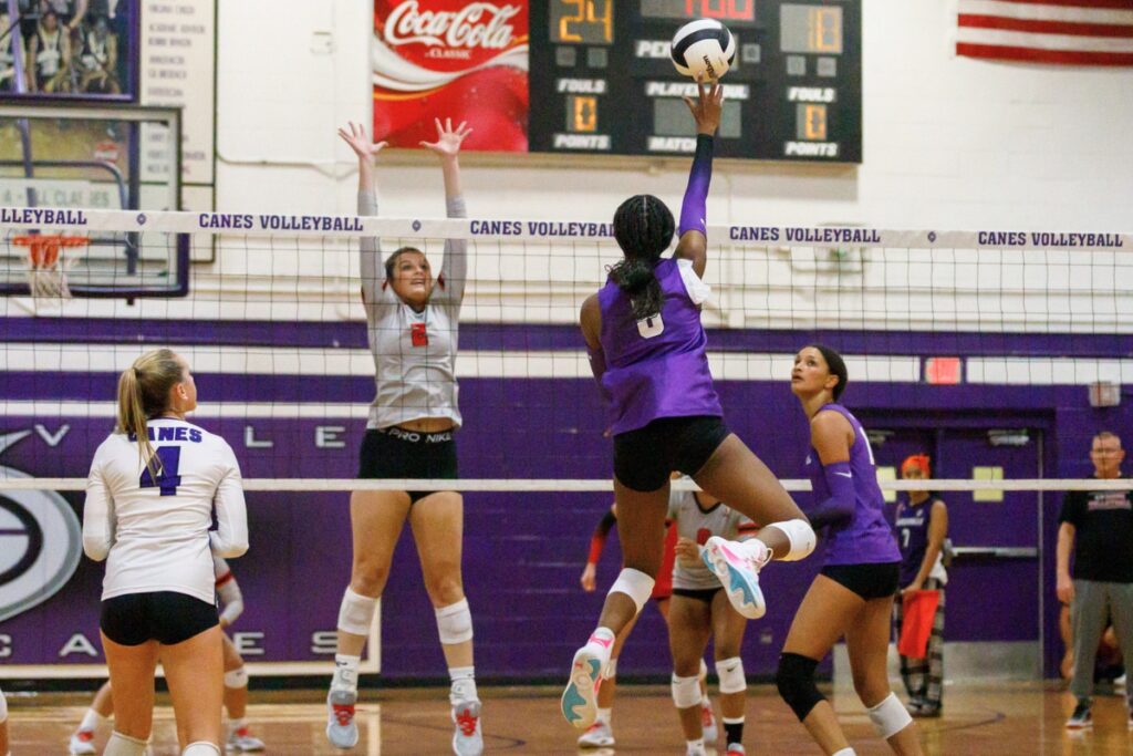 Santa Fe's Emarie Carlisle (2) goes for a block against Gainesville's Jorryn Dye. Photo by Walker Smith