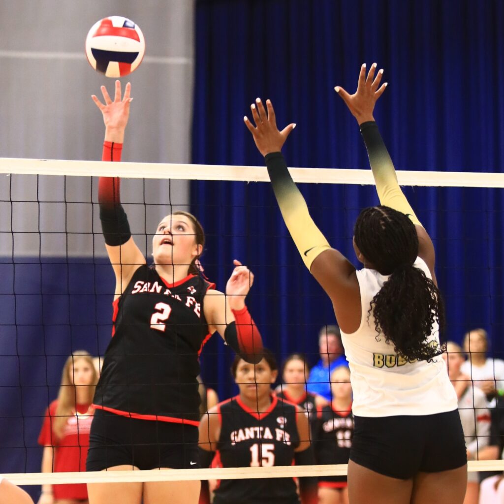 Santa Fe's Emarie Carlisle (2) with a hit against Buchholz's Demmi Strappy (11) at the Crafty Gemini Preseason Showdown on Thursday. Photo by C.J. Gish