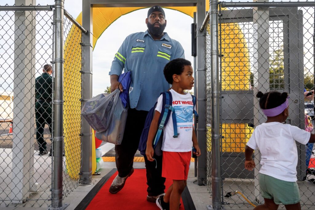 Students walk the red carpet as they enter Oak View K-8 on the first day of school. The newly expanded school opened this year as an alternative to Newberry Community School. Photo by Walker Smith