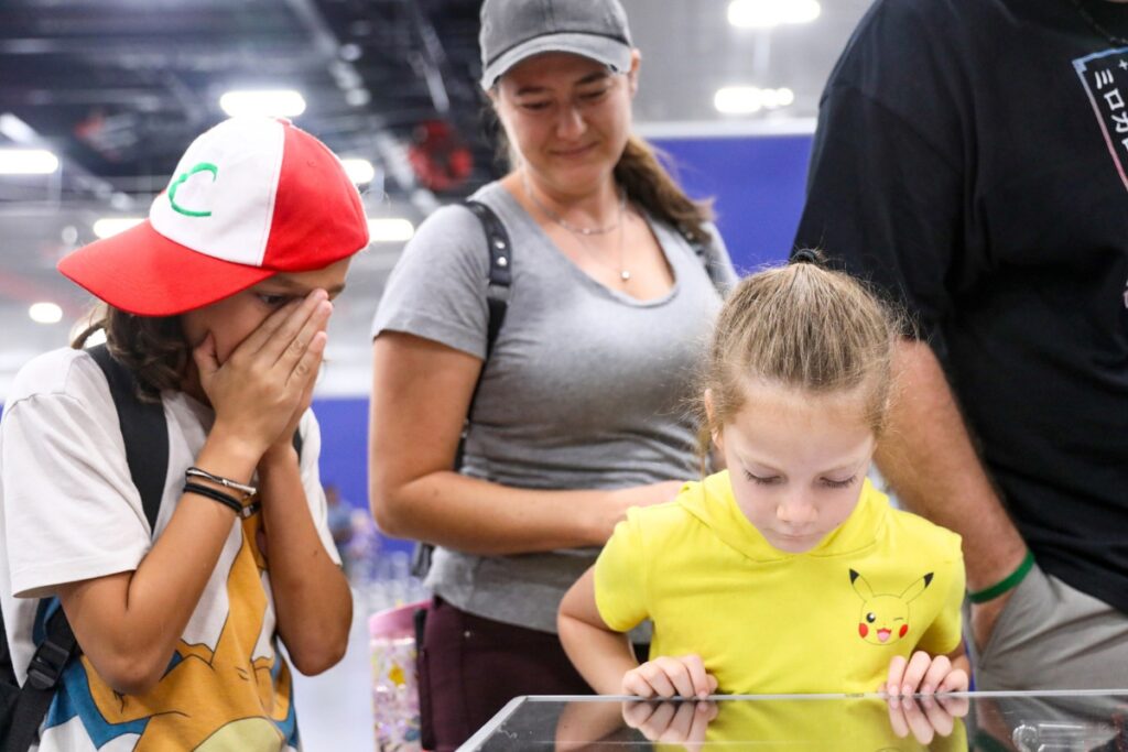 The Diperna family look through sports cards during the Florida Legends event at the Alachua County Sports & Events Center on Sunday. Photo by Walker Smith