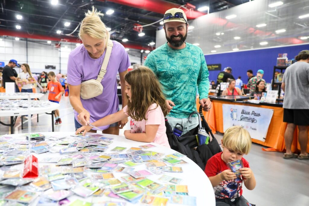 The Guinn family looks through sports cards during the Florida Legends event at the Alachua County Sports & Events Center on Sunday in Gainesville. Photo by Walker Smith