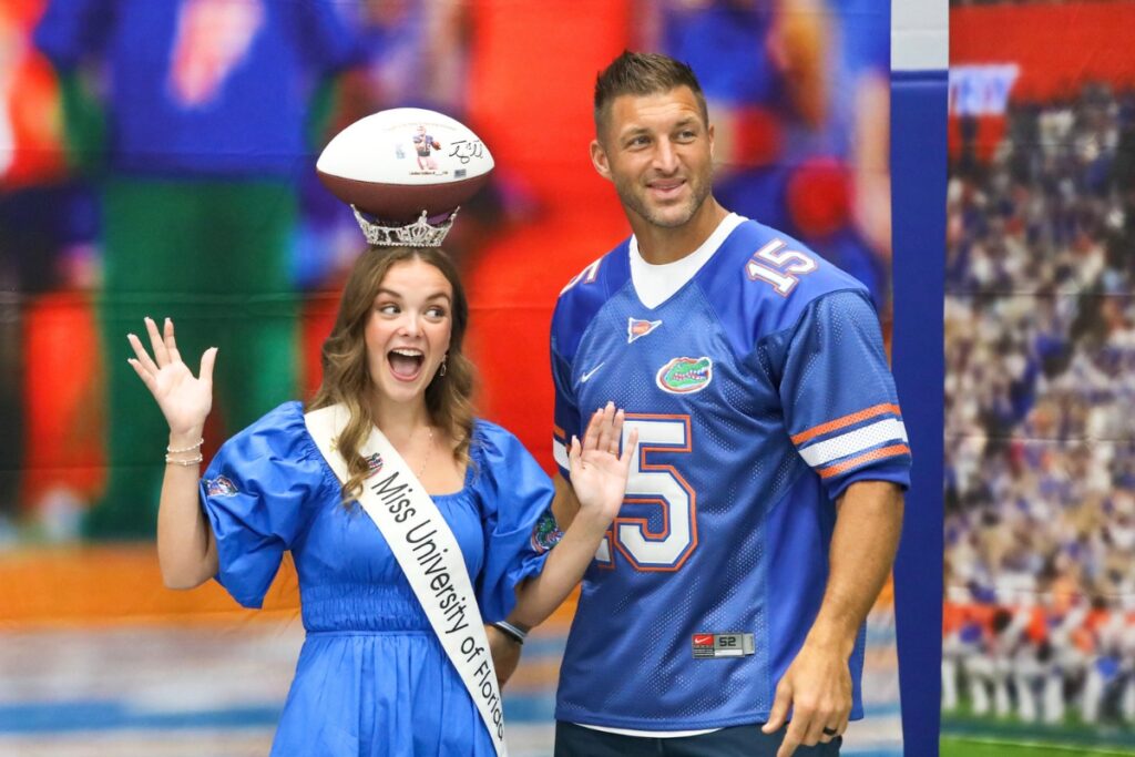 Tim Tebow poses for a photo with Miss University of Florida during the Florida Legends event at the Alachua County Sports & Events Center on Sunday. Photo by Walker Smith.