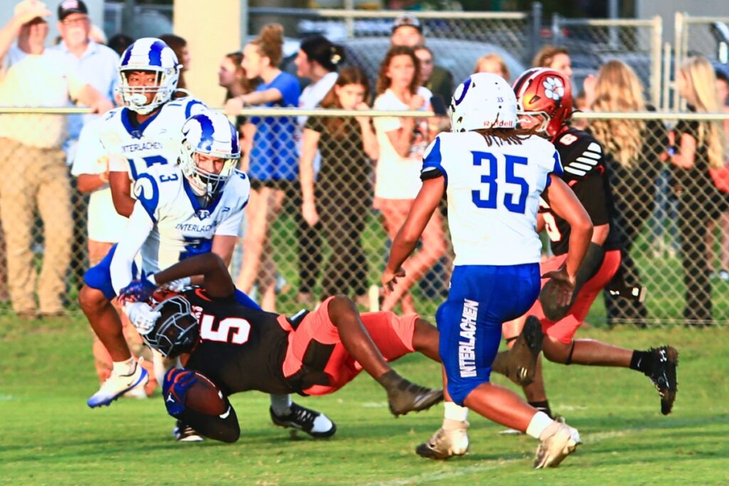 Trenton's Kevone Markham (5) gets tackled by the facemask after a first-quarter catch against Interlachen on Friday. Photo by C.J. Gish