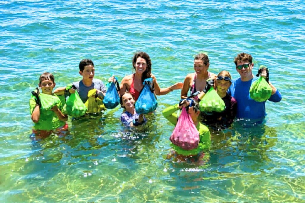 Two families in the water show off the scallop haul. Photo by Captain Mike Farmer