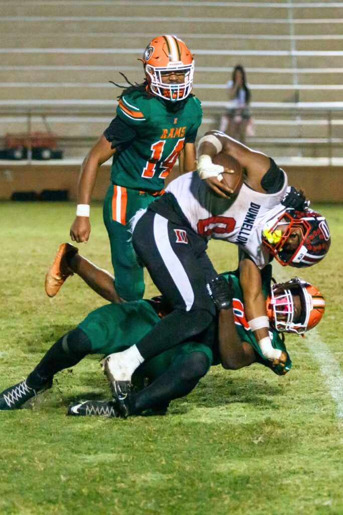 A Dunnellon's Tony Tanner (0) gets brought down by an Eastside defender on Friday. Photo by Walker Smith