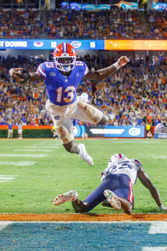 Florida’s Jadan Baugh lunges over Florida Atlantic’s defense for a touchdown during Saturday’s game at Ben Hill Griffin Stadium in Gainesville.