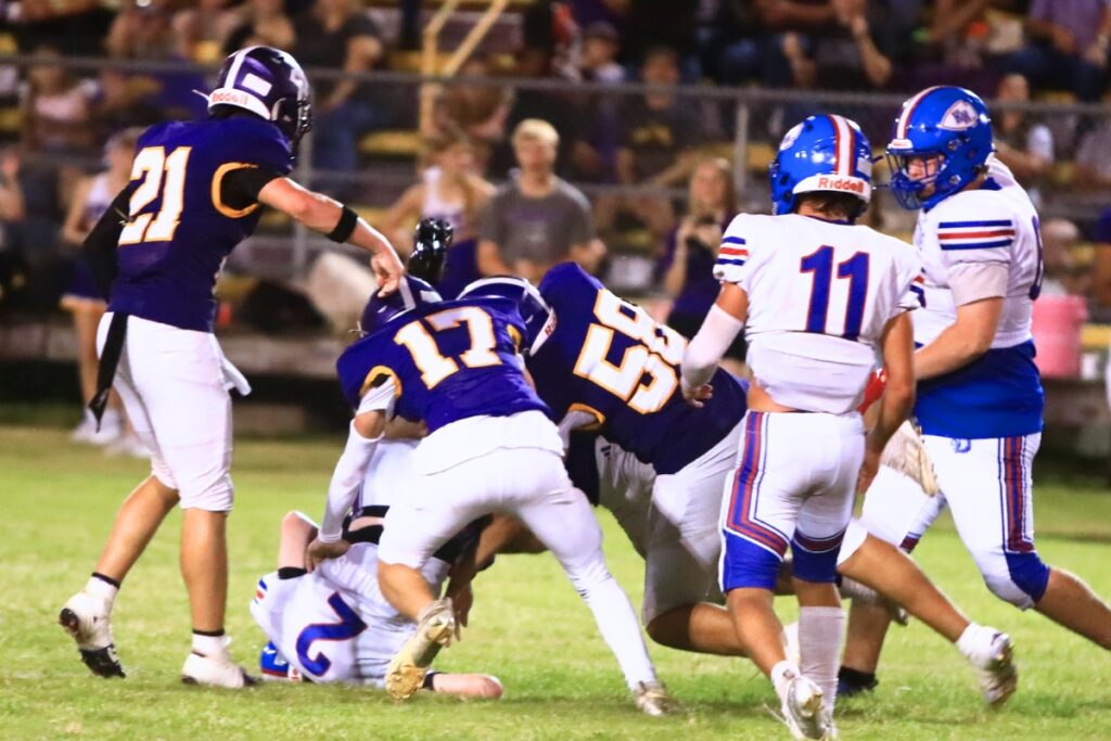 Bell defenders stop Keystone Heights quarterback Connor Mooneyham (2) in the fourth quarter. Photo by C.J. Gish