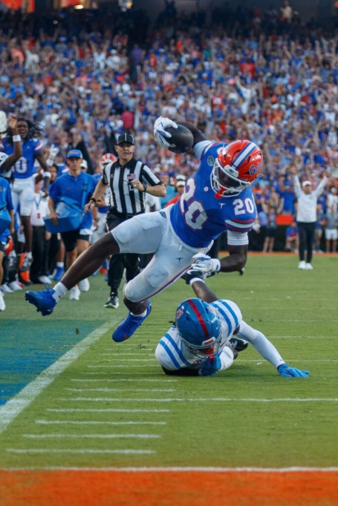 Florida running back Duke Clark lunges through the air while advancing the ball against Ole Miss Saturday at Ben Hill Griffin Stadium.