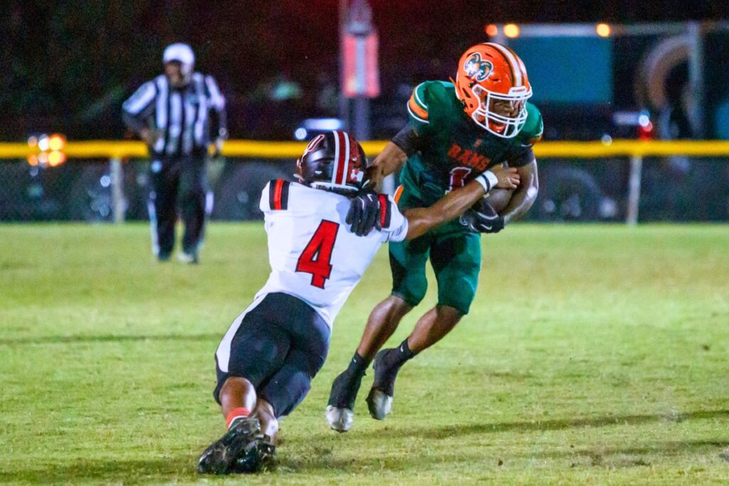 Eastside's Jameer McCarthy (1) attempts to avoid a tackle against Dunnellon on Friday. Photo by Walker Smith