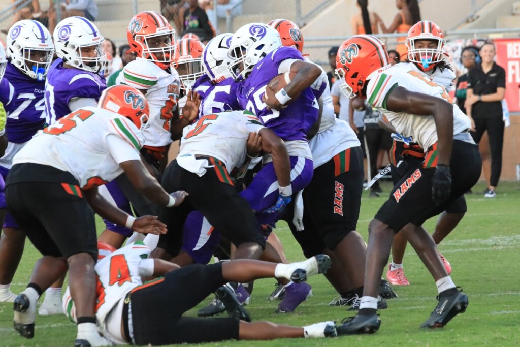 Eastside's defense stops Gainesville's Perry Keihonest (25) on a run. Photo by Seth Johnson