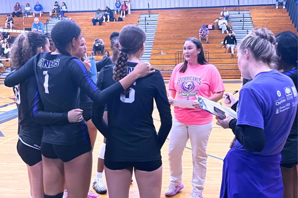 Gainesville coach Jerica Carter-Mitchell (pink shirt) talks to her team in a 3-0 road win against Ridgeview (Orange Park) on Monday. Photo by Mike Ridaught