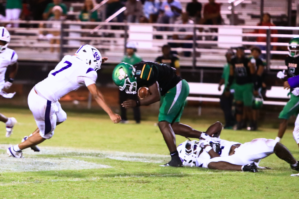 Gainesville's Zohnray Rochelle (7) and Zaire Francis (4) bring down Suwannee's Travon Fead (0) on Friday. Photo by C.J. Gish