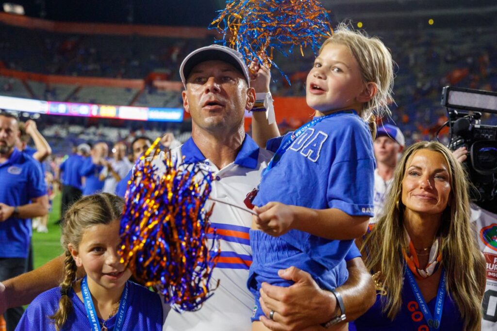 Florida head coach Jon Sumrall celebrates with his family after leading the Gators to a 66-21 victory over Florida Atlantic in the team’s home opener Saturday.