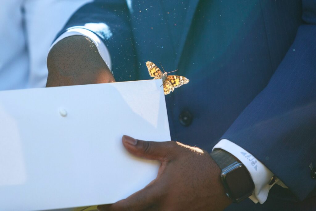 A butterfly clings to the box as Pastor Adrian Taylor of Springhill Church releases butterflies during a ceremony at HCA Florida North Florida Hospital honoring families who have experienced pregnancy or infant loss.