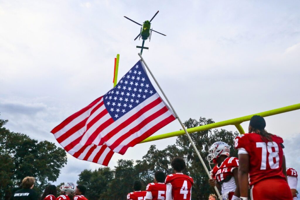 A helicopter flies over the stadium prior to the game thursday evening at Santa Fe high school. Photo by Walker Smith