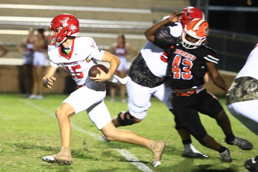 Bradford's Cy Cubbedge (15) scrambles for a first down against Eastside on Friday. Photo by C.J. Gish