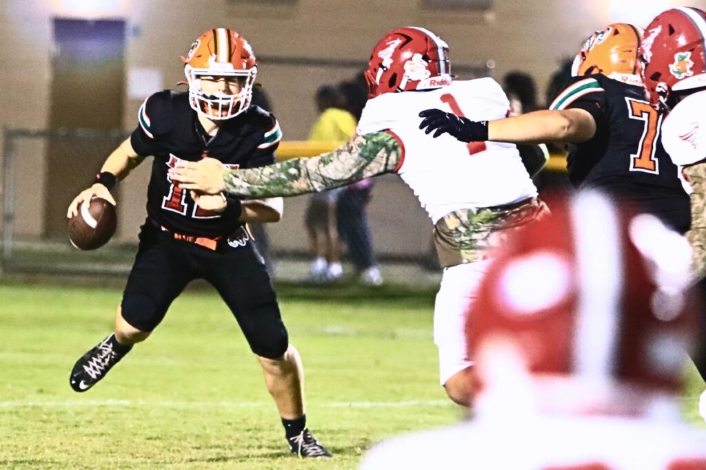 Bradford's Danny Torres (1) sacks Eastside's Andrew Sutherland (12) in the first quarter at Citizens Field on Friday. Photo by C.J. Gish