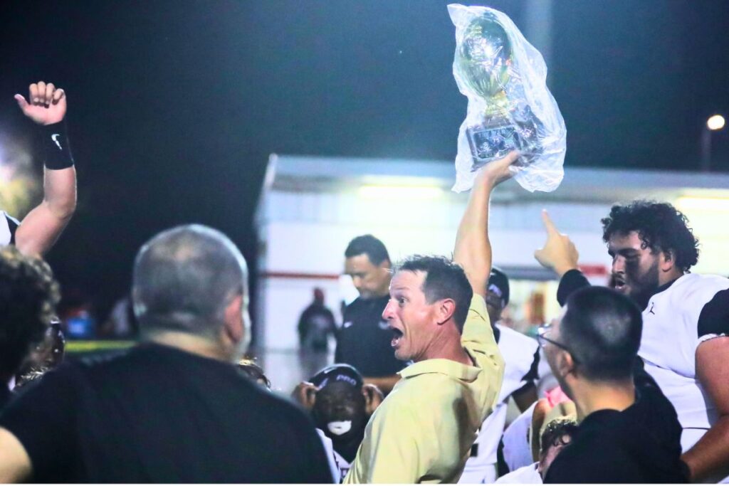 Buchholz head coach Mark Whittemore celebrates with his team after defeating Santa Fe on Thursday night. Photo by Walker Smith