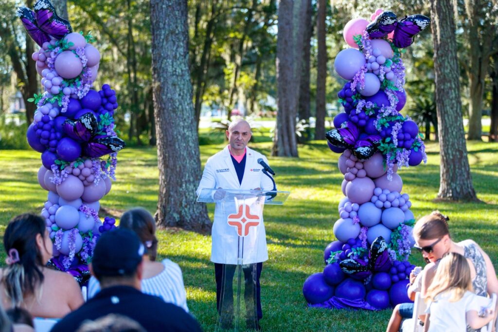 Dr. Alex Gumeroff speaks during the third annual butterfly release at HCA Florida North Florida Hospital. The event provides a space for parents to remember their children and find support from others who have experienced similar losses.