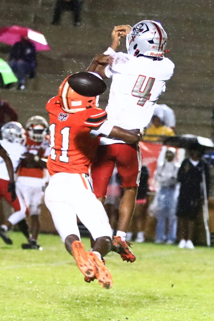 Eastside's Malicah Williams (11) breaks up a pass intended for Santa Fe's Kayoni Briggs (4) on Thursday. Photo by C.J. Gish