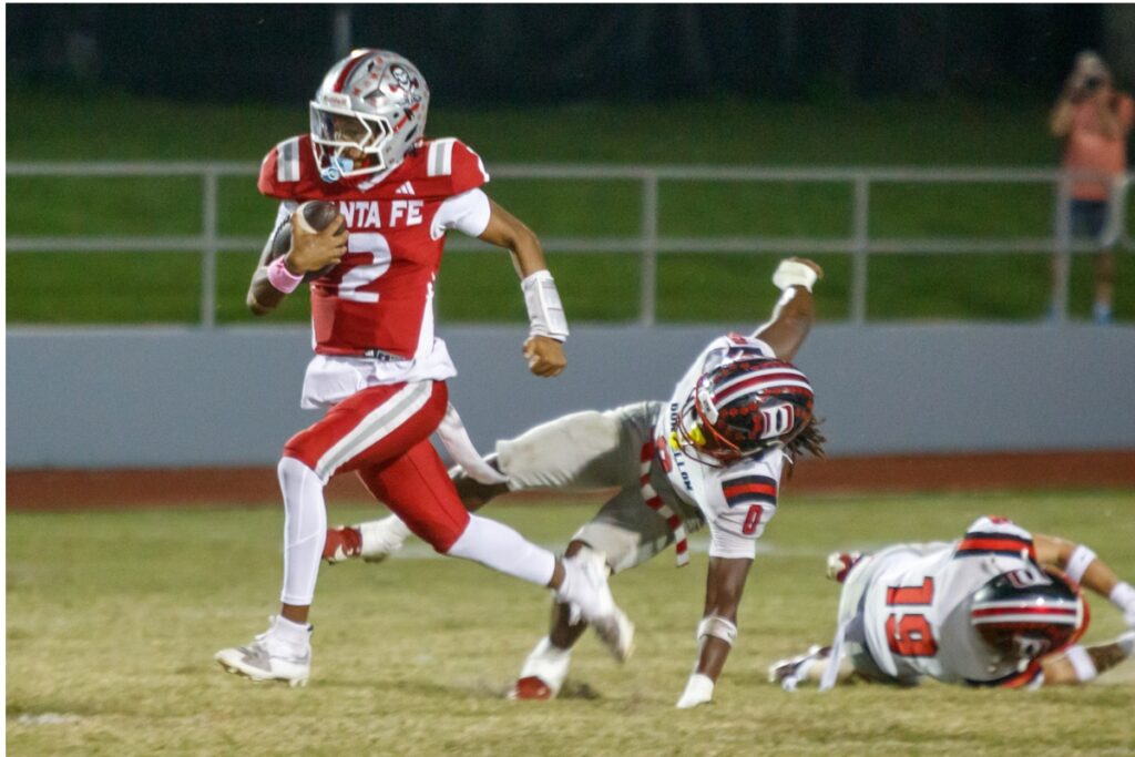 Santa Fe's Gavin Peterson gains yards during a game against Dunnellon on Thursday. Photo by Walker Smith