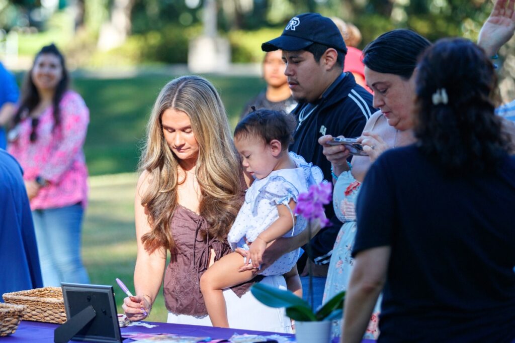 HCA Healthcare workers and families write names on paper butterflies to honor babies lost during pregnancy or infancy at an event on Thursday. Photo by Walker Smith