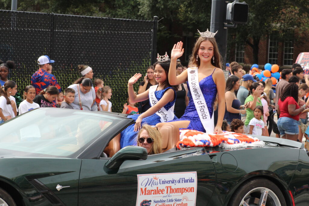 Miss University of Florida Maralee Thompson (right) and Sunshine Little Sister Guiliana Cerdan (left) in the UF Homecoming Parade. (Photo by Nick Anschultz)