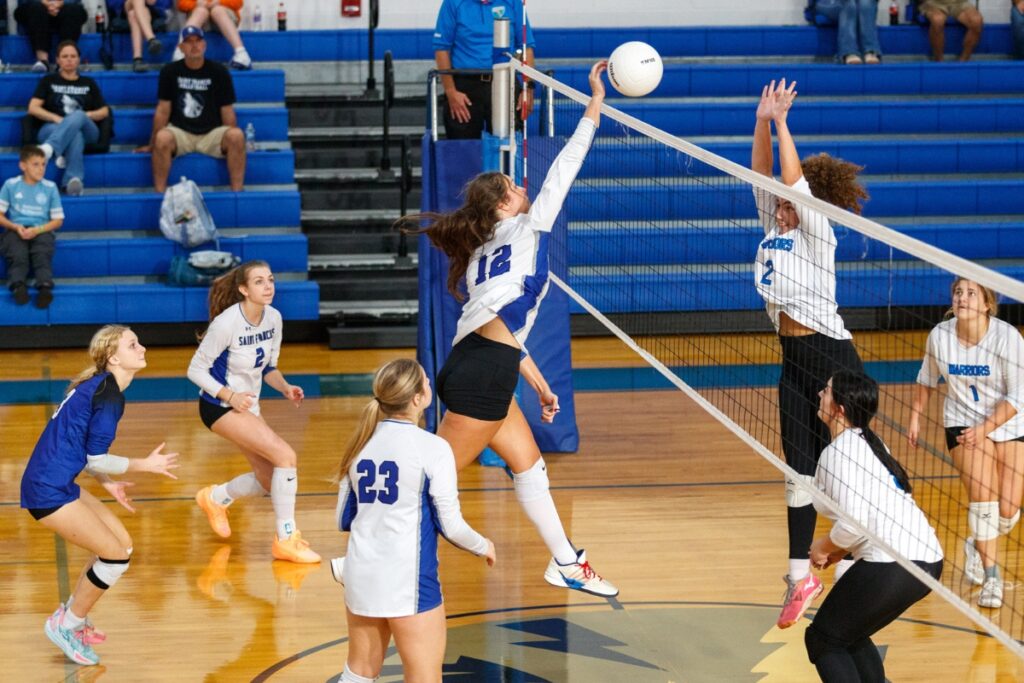 Saint Francis Catholic's Naomi Magary spikes the ball during a match against Peniel Baptist on Wednesday. Photo by Walker Smith