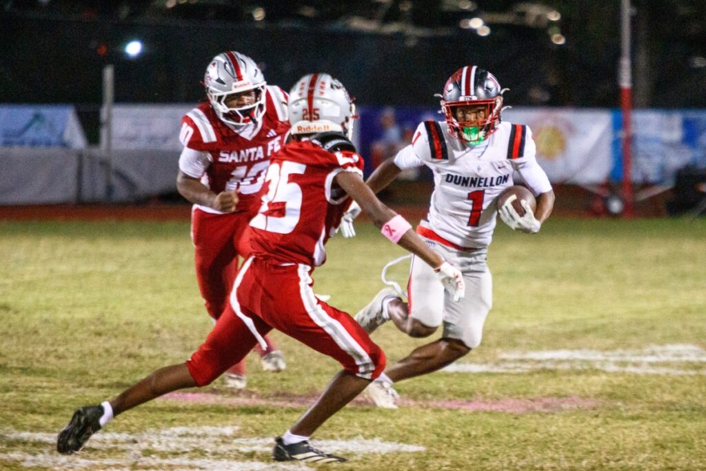 Santa Fe defenders go for a tackle Dunnellon's Elias Williams on Thursday. Photo by Walker Smith