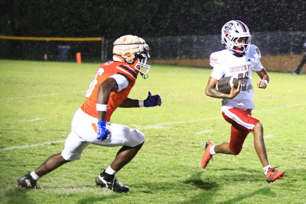 Santa Fe's Kayoni Briggs (4) with the opening kickoff return against Eastside on Thursday. Photo by C.J. Gish