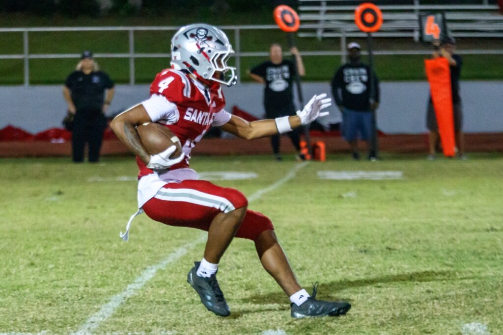 Santa Fe's Kayoni Briggs looks for an opening to advance down the field during a game against Dunnellon on Thursday. Photo by Walker Smith
