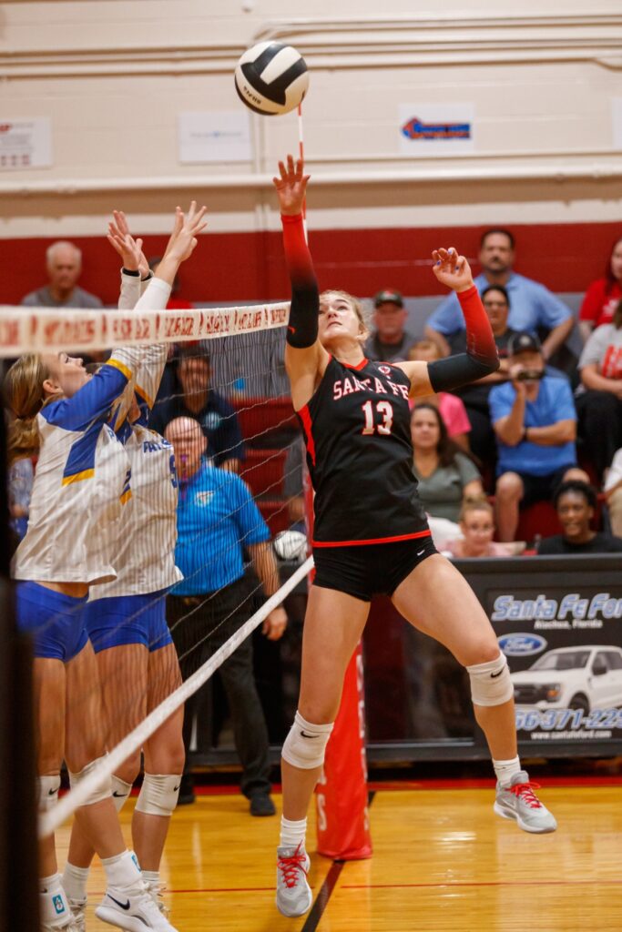 Santa Fe's Taylor Sembower leaps to return the ball in the Class 3A-District 5 championship match against Newberry on Thursday. Photo by Walker Smith