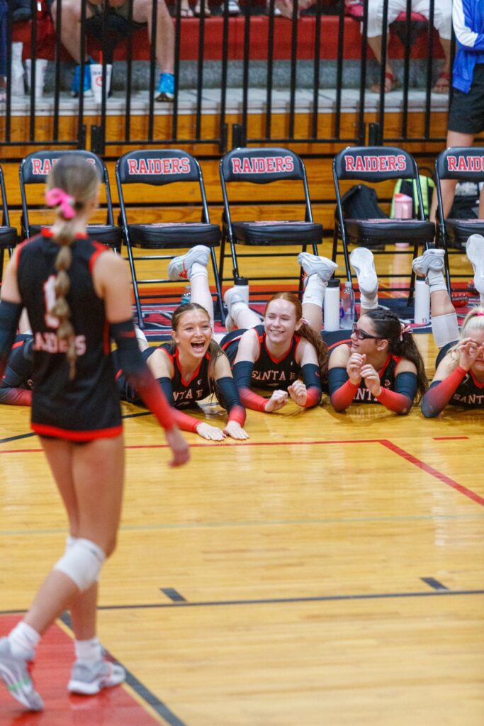 Santa Fe's volleyball team lunges to the floor in celebration after scoring a point in the Class 3A-District 5 championship match against Newberry on Thursday. Photo by Walker Smith