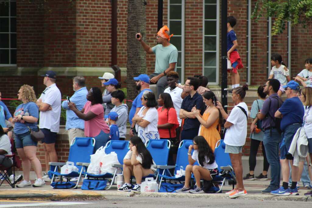 Spectators watch the UF Homecoming Parade at the corner of 13th Street and University Avenue. (Photo by Nick Anschultz)